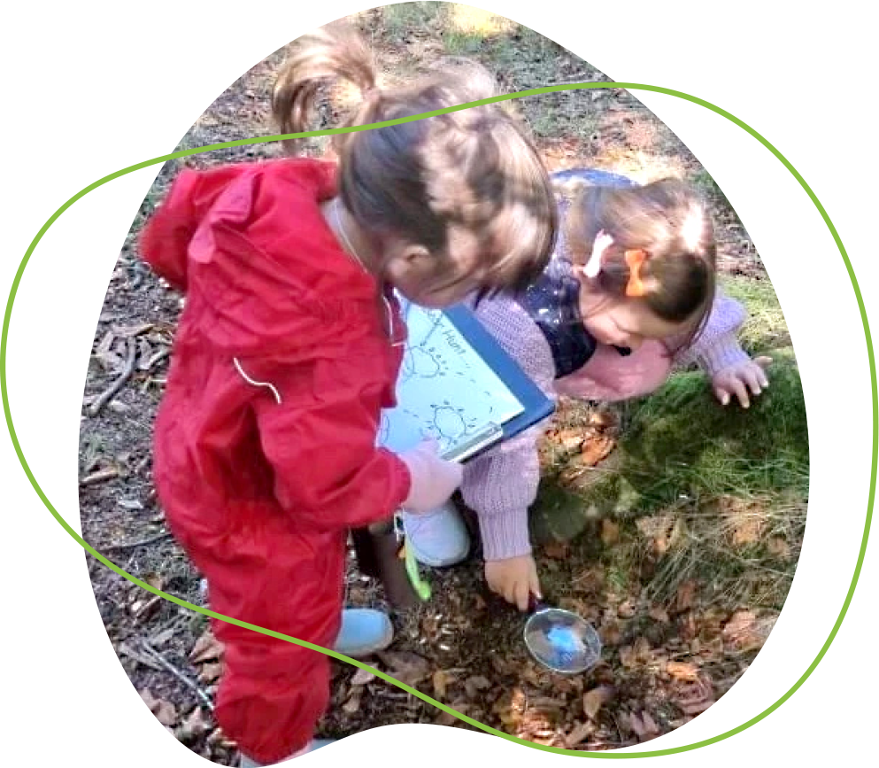 Young children exploring and investigating during an outdoor play session